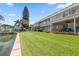 Spacious backyard with lush green grass, overlooking a canal at 400 Larboard Way # 106, Clearwater Beach, FL 33767