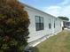 Side view of manufactured home showcasing vinyl siding at 231 Tarpon Ln, Oldsmar, FL 34677