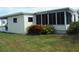 Well-maintained manufactured home with carport and attractive landscaping at 231 Tarpon Ln, Oldsmar, FL 34677
