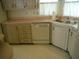 Kitchen corner sink with light colored cabinets and a dishwasher at 231 Tarpon Ln, Oldsmar, FL 34677