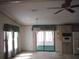 Bright dining room with a chandelier, window curtains, and access to a sunroom at 231 Tarpon Ln, Oldsmar, FL 34677