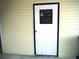 Exterior view of a white door at 231 Tarpon Ln, Oldsmar, FL 34677