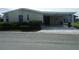Mobile home with carport and well-maintained landscaping at 231 Tarpon Ln, Oldsmar, FL 34677