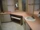 Double vanity with a pink countertop and bench at 231 Tarpon Ln, Oldsmar, FL 34677