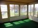 Sunroom with green carpeting, multiple windows, and a view of the backyard at 231 Tarpon Ln, Oldsmar, FL 34677