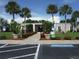 Community building entrance with landscaping and parking at 231 Tarpon Ln, Oldsmar, FL 34677