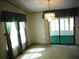 Bright dining room with a chandelier, window curtains, and access to a sunroom at 231 Tarpon Ln, Oldsmar, FL 34677