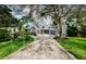 Beautiful two-story home with a large driveway and lush landscaping at 1142 Weybridge Ln, Dunedin, FL 34698