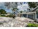 Gray house with landscaping and a long driveway at 1142 Weybridge Ln, Dunedin, FL 34698