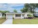 House exterior with a driveway and well-maintained lawn at 3713 Luma Dr, Holiday, FL 34691