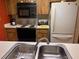 Galley kitchen with stove, microwave and refrigerator at 2587 Countryside Blvd # 6204, Clearwater, FL 33761
