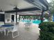 Relaxing pool area with tables, chairs, and lush landscaping at 2587 Countryside Blvd # 6204, Clearwater, FL 33761