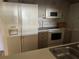 Galley kitchen with white appliances and ample counter space at 2587 Countryside Blvd # 6306, Clearwater, FL 33761