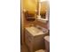 Cozy bathroom featuring a vanity with a sink, a mirror, and decorative towels on a towel rack at 8665 Mockingbird Ln, Seminole, FL 33777