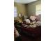 Picture of cluttered bedroom with belongings strewn across the bed and surfaces, with two windows for light at 8665 Mockingbird Ln, Seminole, FL 33777