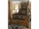 Traditional bedroom with a four-poster bed and decorative pillows and bedding at 8665 Mockingbird Ln, Seminole, FL 33777
