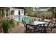 Backyard pool area with patio furniture, lush landscaping, and a pool house providing a relaxing outdoor space at 8665 Mockingbird Ln, Seminole, FL 33777