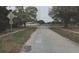 A street view showcasing the property's location on Mockingbird Lane, with surrounding trees and sidewalks at 8665 Mockingbird Ln, Seminole, FL 33777