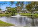 Peaceful pond with fountain in a lush green landscape at 4001 58Th N St # 16, Kenneth City, FL 33709