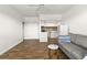 Open living area with gray sofa and kitchenette at 4001 58Th N St # 16, Kenneth City, FL 33709