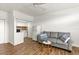 Open living area with gray sofa and kitchenette at 4001 58Th N St # 16, Kenneth City, FL 33709