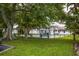 Community shuffleboard court with benches under shade trees at 4001 58Th N St # 16, Kenneth City, FL 33709