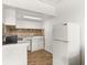 Small galley kitchen with white cabinets and tile backsplash at 4001 58Th N St # 16, Kenneth City, FL 33709