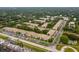 Aerial view of an apartment community with ample parking and lush landscaping at 4001 58Th N St # 16, Kenneth City, FL 33709