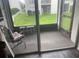 Screened patio with chair and view of grassy area at 2625 State Road 590 # 2711, Clearwater, FL 33759