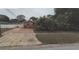 House with cracked driveway and landscaping at 8665 Mockingbird Ln, Seminole, FL 33777