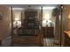 Cozy bedroom with a four poster bed and decorative lamps at 8665 Mockingbird Ln, Seminole, FL 33777