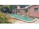 Relaxing kidney-shaped swimming pool next to the house at 8665 Mockingbird Ln, Seminole, FL 33777