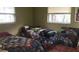 Cozy bedroom with two twin beds and large windows at 8665 Mockingbird Ln, Seminole, FL 33777