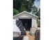 Outdoor storage shed with roll-up door at 8665 Mockingbird Ln, Seminole, FL 33777