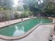 Kidney-shaped swimming pool in backyard at 8665 Mockingbird Ln, Seminole, FL 33777