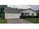 Brick ranch home with carport, well-manicured lawn, and mature shrubs at 4714 Cavendish Dr, New Port Richey, FL 34655
