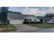 Front view of a house showing landscaping and neighborhood context at 4714 Cavendish Dr, New Port Richey, FL 34655
