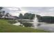 Scenic lake view with fountain and community building at 4714 Cavendish Dr, New Port Richey, FL 34655