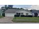 White brick house with a green lawn and shrubs at 4714 Cavendish Dr, New Port Richey, FL 34655