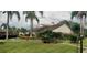 Community clubhouse with landscaping and palm trees at 4714 Cavendish Dr, New Port Richey, FL 34655