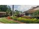 Landscaped grounds with flowering bushes near the clubhouse at 4714 Cavendish Dr, New Port Richey, FL 34655