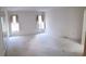 Large bedroom with ample natural light and carpet at 4714 Cavendish Dr, New Port Richey, FL 34655