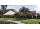 Community clubhouse with lush landscaping and flag at 4714 Cavendish Dr, New Port Richey, FL 34655