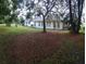 Back of house nestled amongst trees, showing a spacious yard at 4714 Cavendish Dr, New Port Richey, FL 34655