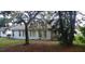 Back of the house with landscaping and trees at 4714 Cavendish Dr, New Port Richey, FL 34655