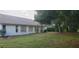 Spacious backyard with grassy area and mature trees at 4714 Cavendish Dr, New Port Richey, FL 34655