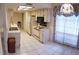 Bright kitchen features ample cabinetry and a view into the adjoining living area at 4714 Cavendish Dr, New Port Richey, FL 34655