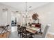Elegant dining room with a rustic wood table, chandelier, and access to other rooms at 11519 Belle Haven Dr, New Port Richey, FL 34654