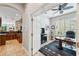 Spacious home office with built-in bookshelves and kitchen views at 11519 Belle Haven Dr, New Port Richey, FL 34654