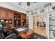 Well-appointed home office with custom cabinetry and views into the dining area at 11519 Belle Haven Dr, New Port Richey, FL 34654